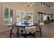 Elegant dining area with round table, chandelier, shuttered windows, and modern decor at 1808 S Sailors Way, Gilbert, AZ 85295