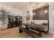 Charming dining room with stylish lighting, a wooden table with bench, and a decorative wall feature at 1808 S Sailors Way, Gilbert, AZ 85295