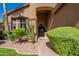 Inviting front entryway with black door, rock wall, and lush landscaping at 1808 S Sailors Way, Gilbert, AZ 85295
