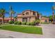 Beautiful home featuring lush green lawn with attractive desert landscaping at 1808 S Sailors Way, Gilbert, AZ 85295