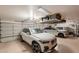 Spacious garage with custom storage solutions, overhead racks, and room for multiple vehicles and equipment at 1808 S Sailors Way, Gilbert, AZ 85295