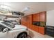 Spacious garage featuring custom cabinetry, overhead storage racks, and ample room for multiple vehicles and tools at 1808 S Sailors Way, Gilbert, AZ 85295