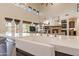 Gourmet kitchen island features a farmhouse sink, stainless steel appliances, and a seamless countertop at 1808 S Sailors Way, Gilbert, AZ 85295