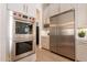 Modern kitchen with stainless steel appliances including a double oven and refrigerator at 1808 S Sailors Way, Gilbert, AZ 85295