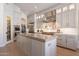 Bright kitchen with stainless steel appliances, center island, modern cabinets, and wood flooring at 1808 S Sailors Way, Gilbert, AZ 85295