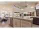 Spacious kitchen featuring a large island with seating, stainless steel appliances, and views to the living and dining areas at 1808 S Sailors Way, Gilbert, AZ 85295