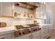 Gourmet kitchen featuring professional-grade appliances, custom cabinetry, and sleek countertops and backsplash at 1808 S Sailors Way, Gilbert, AZ 85295