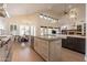 Open kitchen with a large island, stainless steel appliances, and views to the living and dining areas at 1808 S Sailors Way, Gilbert, AZ 85295