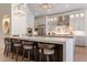 Kitchen featuring a long center island with seating, stainless appliances, and pendant lighting at 1808 S Sailors Way, Gilbert, AZ 85295