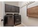Spacious laundry room with cabinetry, utility sink, side by side washer/dryer, and hanging racks at 1808 S Sailors Way, Gilbert, AZ 85295