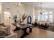 Open-concept living and dining area with hardwood floors, stylish lighting, and comfortable seating at 1808 S Sailors Way, Gilbert, AZ 85295