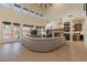 Bright living room featuring stone fireplace, built-in shelving, and backyard access at 1808 S Sailors Way, Gilbert, AZ 85295