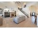 Bright living room with stone fireplace, built-in shelves, and staircase access at 1808 S Sailors Way, Gilbert, AZ 85295