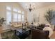 Bright living room boasts a large window, neutral color palette, and modern decor at 1808 S Sailors Way, Gilbert, AZ 85295