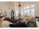 Elegant living room featuring a large window, chandelier lighting, and sleek, modern furniture at 1808 S Sailors Way, Gilbert, AZ 85295
