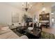 Open living room with wood-look flooring, elegant chandeliers, and comfortable seating at 1808 S Sailors Way, Gilbert, AZ 85295