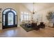 Open-concept living room showcasing a sofa set, large windows, and vaulted ceiling at 1808 S Sailors Way, Gilbert, AZ 85295