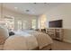Well-lit main bedroom with private access to backyard and view to the ensuite bath at 1808 S Sailors Way, Gilbert, AZ 85295