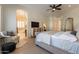 Well-lit main bedroom with hardwood floors and access to the ensuite bathroom at 1808 S Sailors Way, Gilbert, AZ 85295