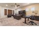 Spacious office features dual desks, built-in storage, a leather couch, and large windows for ample light at 1808 S Sailors Way, Gilbert, AZ 85295