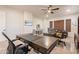 Bright home office featuring a ceiling fan, dual desks, and large windows for ample natural light at 1808 S Sailors Way, Gilbert, AZ 85295