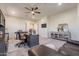 Bright home office with neutral walls, ceiling fan, built-in shelving, and an attractive seating area at 1808 S Sailors Way, Gilbert, AZ 85295
