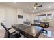 Bright home office featuring a ceiling fan, dual desks, and large windows for ample natural light at 1808 S Sailors Way, Gilbert, AZ 85295