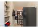 Well-organized pantry with shelving, food storage, and a modern black refrigerator for convenient kitchen storage at 1808 S Sailors Way, Gilbert, AZ 85295