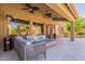 Inviting covered patio with ample seating, a stylish fire pit, and ceiling fans for comfortable outdoor living at 1808 S Sailors Way, Gilbert, AZ 85295