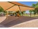 Community playground featuring a large sunshade, climbing structures, swings, and picnic area at 1808 S Sailors Way, Gilbert, AZ 85295