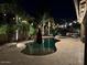 The pool and patio area has palm trees and string lights for a relaxing atmosphere at 1808 S Sailors Way, Gilbert, AZ 85295