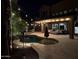 A private backyard pool at night is illuminated by ambient and string lights for elegant outdoor living at 1808 S Sailors Way, Gilbert, AZ 85295