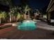 The pool has a rock waterfall feature and is surrounded by palm trees and lounge seating at 1808 S Sailors Way, Gilbert, AZ 85295