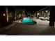 The pool area has stone pavers, palm trees, a rock waterfall feature, and patio seating at 1808 S Sailors Way, Gilbert, AZ 85295