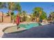 Serene backyard pool and spa featuring a waterfall, mature palm trees, and a relaxing ambiance for outdoor enjoyment at 1808 S Sailors Way, Gilbert, AZ 85295