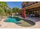 Gorgeous pool area with a built-in spa, rock waterfall, and comfortable seating at 1808 S Sailors Way, Gilbert, AZ 85295
