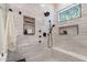 Modern shower features marble tile, built-in niche, and a rainfall shower head at 1808 S Sailors Way, Gilbert, AZ 85295