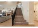 Carpeted staircase leading to the upper level of the home, with living room views at 1808 S Sailors Way, Gilbert, AZ 85295