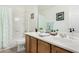 Bright bathroom features a double sink vanity, framed mirror, decor, shower and toilet at 18903 N Shelby Dr, Maricopa, AZ 85138