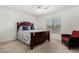 Bedroom with carpet, fan, window with blinds, with a chair, and a bed at 18903 N Shelby Dr, Maricopa, AZ 85138