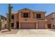 Two-story home featuring a tile roof, two-car garage, and desert landscaping at 18903 N Shelby Dr, Maricopa, AZ 85138