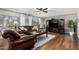 Cozy living room with hardwood floors, ceiling fan, and large windows at 18903 N Shelby Dr, Maricopa, AZ 85138
