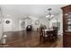 Open concept living and dining area with hardwood floors and bright natural light at 18903 N Shelby Dr, Maricopa, AZ 85138