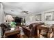 Cozy living room with hardwood floors, ceiling fan, and leather furnishings at 18903 N Shelby Dr, Maricopa, AZ 85138