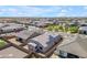 Expansive aerial view of a neighborhood featuring homes equipped with solar panels and a community playground at 18916 W Laurel Ln, Surprise, AZ 85388