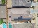 An overhead shot showcases a residence equipped with solar panels, adjacent to a refreshing pool and well-kept yard at 18916 W Laurel Ln, Surprise, AZ 85388