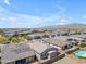 Aerial view of the neighborhood featuring community parks, pools, and solar panels at 18916 W Laurel Ln, Surprise, AZ 85388