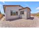 Paver-covered backyard with desert landscaping and a neutral-colored stucco home at 18916 W Laurel Ln, Surprise, AZ 85388