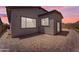 Paver-covered backyard with desert landscaping and a neutral stucco home exterior at 18916 W Laurel Ln, Surprise, AZ 85388