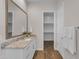 Modern bathroom features granite counters, decorative mirror and opens to walk-in closet at 18916 W Laurel Ln, Surprise, AZ 85388